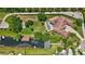 Overhead view of a luxurious home with a pool, boat dock, and beautifully landscaped grounds at 10352 Burris Ct, Orlando, FL 32836