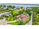 Beautiful aerial view of a waterfront property, showcasing the landscape, pool, and lake access at 10352 Burris Ct, Orlando, FL 32836
