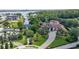 Aerial view of the home with mature landscaping, and a view of the lake at 10352 Burris Ct, Orlando, FL 32836