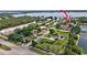Aerial view of a neighborhood with mature landscaping, tennis courts, and lake views at 10352 Burris Ct, Orlando, FL 32836
