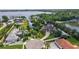 Stunning aerial view of the property showcasing its lush landscaping, circular driveway, and prime location near the lake at 10352 Burris Ct, Orlando, FL 32836