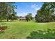 Wide backyard with lush green lawn and view of house and boathouse at 10352 Burris Ct, Orlando, FL 32836