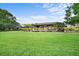Expansive backyard with lush green lawn and boathouse on the water at 10352 Burris Ct, Orlando, FL 32836