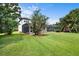 Beautiful backyard with green lawn and a screened-in patio at 10352 Burris Ct, Orlando, FL 32836
