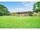 Lush backyard with a private boat dock and verdant lawn, perfect for waterfront living at 10352 Burris Ct, Orlando, FL 32836