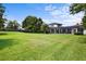Sprawling backyard with well-kept lawn and screened-in patio area at 10352 Burris Ct, Orlando, FL 32836
