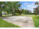 Outdoor basketball court in backyard with trees and well-maintained grass at 10352 Burris Ct, Orlando, FL 32836