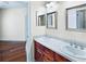 Bright bathroom featuring double sinks, granite countertops, and modern fixtures at 10352 Burris Ct, Orlando, FL 32836