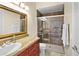 Modern bathroom with a glass-enclosed shower, granite countertop, and updated fixtures at 10352 Burris Ct, Orlando, FL 32836