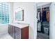 Bathroom featuring granite counters, a closet, and a decorative glass block window at 10352 Burris Ct, Orlando, FL 32836