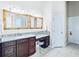 Bathroom featuring granite counters, framed mirrors, and a makeup vanity at 10352 Burris Ct, Orlando, FL 32836