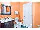 Cozy powder room features ornate mirror, dark wood vanity, and tiled floor, creating a stylish space at 10352 Burris Ct, Orlando, FL 32836