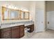 Vanity with granite countertop, dual sinks, and a dedicated makeup area at 10352 Burris Ct, Orlando, FL 32836