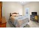 Bright bedroom features neutral walls, colorful bedding, and tiled floors at 10352 Burris Ct, Orlando, FL 32836