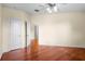 Empty bedroom with hardwood floors, two doors, and neutral-colored walls at 10352 Burris Ct, Orlando, FL 32836