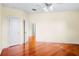 Spacious bedroom with hardwood floors, ceiling fan, and neutral paint, creating a bright, welcoming space at 10352 Burris Ct, Orlando, FL 32836