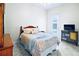 Cozy bedroom with a decorative bed, tiled floor, and access to the outdoor area at 10352 Burris Ct, Orlando, FL 32836