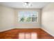 Bedroom featuring wood floors and a sunlit window at 10352 Burris Ct, Orlando, FL 32836