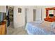Bedroom featuring a bed with patterned covers and a view of a walk-in closet at 10352 Burris Ct, Orlando, FL 32836