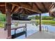 Covered boat lift in boathouse with watercraft and access to the lake at 10352 Burris Ct, Orlando, FL 32836