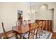 Formal dining room features a grand chandelier, large wood table, and elegant decor at 10352 Burris Ct, Orlando, FL 32836