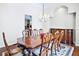 Formal dining room features a grand wooden table, elegant chairs, and a decorative chandelier at 10352 Burris Ct, Orlando, FL 32836