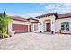Elegant exterior showcasing a paver driveway, attached garage, and columned front entrance at 10352 Burris Ct, Orlando, FL 32836