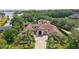 Aerial view of a beautiful single-Gathering home with lush landscaping, a driveway, and a grand entrance at 10352 Burris Ct, Orlando, FL 32836
