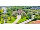 Stunning waterfront estate featuring lush landscaping, tile roof, and a grand driveway at 10352 Burris Ct, Orlando, FL 32836