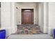 Inviting entryway with colorful tiled floor and large columns framing the front door at 10352 Burris Ct, Orlando, FL 32836