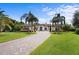 Stunning villa with a circular driveway, lush landscaping, and grand entrance at 10352 Burris Ct, Orlando, FL 32836