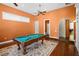 A game room boasting a pool table, hardwood floors, and neutral paint at 10352 Burris Ct, Orlando, FL 32836