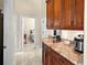 Hallway with a view into the bedroom and kitchen with stone countertops at 10352 Burris Ct, Orlando, FL 32836