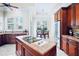 Kitchen area showcasing granite countertops, stainless steel appliances, and an adjacent breakfast nook at 10352 Burris Ct, Orlando, FL 32836