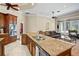 Kitchen featuring granite countertops, stainless steel appliances and views of the living space at 10352 Burris Ct, Orlando, FL 32836