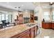 Spacious kitchen featuring granite countertops, stainless steel appliances, and an open design flowing into the living area at 10352 Burris Ct, Orlando, FL 32836