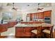 Spacious kitchen with granite countertops, wood cabinetry, and an open view into the dining area at 10352 Burris Ct, Orlando, FL 32836
