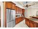 Spacious kitchen featuring wood cabinets, stainless steel fridge, and granite countertops at 10352 Burris Ct, Orlando, FL 32836