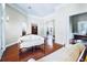 Bright living room with hardwood floors, white sofas, and views of the foyer and office at 10352 Burris Ct, Orlando, FL 32836