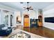 Bright living room featuring a fireplace, built-in shelving, and a view of the billiard room at 10352 Burris Ct, Orlando, FL 32836