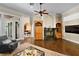 Living room with fireplace, built-in shelves, hardwood flooring, and large windows leading to outdoor seating at 10352 Burris Ct, Orlando, FL 32836