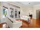 Living room with wood floors, French doors and comfortable seating arrangement at 10352 Burris Ct, Orlando, FL 32836