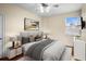 Main bedroom featuring a plush bed, stylish decor, and a sunlit window, on top of an ornate rug at 10352 Burris Ct, Orlando, FL 32836