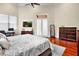 Spacious main bedroom features a ceiling fan, a high ceiling and an ensuite bathroom at 10352 Burris Ct, Orlando, FL 32836