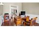 Office with wood floors and desk with an open view to the living room at 10352 Burris Ct, Orlando, FL 32836