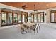 Covered patio with a dining set, ceiling fans, and clear views of the pool at 10352 Burris Ct, Orlando, FL 32836