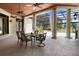 Outdoor dining area features a table with chairs, a ceiling fan, and pool views at 10352 Burris Ct, Orlando, FL 32836