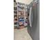Well-stocked pantry featuring wire baskets and organized shelving next to refrigerator at 10352 Burris Ct, Orlando, FL 32836