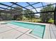 Screened-in pool features a spa and views of the well-maintained lawn at 10352 Burris Ct, Orlando, FL 32836