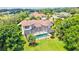 A gorgeous backyard with a large screened-in pool surrounded by lush tropical landscaping at 10352 Burris Ct, Orlando, FL 32836